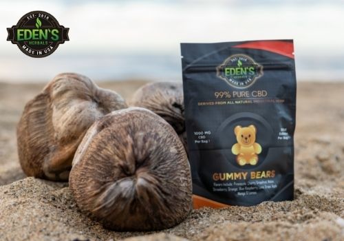 eden's herbals cbd gummies on the beach with coconuts